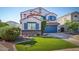 Two-story house with blue garage door and landscaped lawn at 775 E Leslie Ave, San Tan Valley, AZ 85140