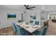 Dining area with a marble table and teal chairs, open to kitchen at 7428 E Carol Cir, Mesa, AZ 85208