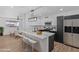 Modern kitchen featuring white and dark cabinets, and a breakfast bar at 7428 E Carol Cir, Mesa, AZ 85208