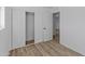 Bedroom with double door closet and hardwood floors at 7428 E Carol Cir, Mesa, AZ 85208