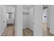 Clean hallway with linen closet and light wood floors at 7428 E Carol Cir, Mesa, AZ 85208