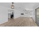 Spacious living room with hardwood floors, fireplace, and access to backyard at 7428 E Carol Cir, Mesa, AZ 85208
