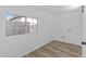 Laundry room with hardwood floors and a window for natural light at 7428 E Carol Cir, Mesa, AZ 85208