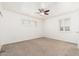Bright bedroom with carpeted floor, ceiling fan, and window with shutters at 5745 N 13Th St, Phoenix, AZ 85014