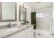 Updated bathroom with double vanity, granite countertops, and a tub shower at 5745 N 13Th St, Phoenix, AZ 85014
