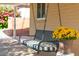 Relaxing porch swing with black frame and striped cushion at 5745 N 13Th St, Phoenix, AZ 85014