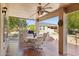 Covered patio features dining area and built-in grill at 15758 W Edgemont Ave, Goodyear, AZ 85395