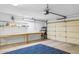 Garage with workbench, storage, and flooring at 15758 W Edgemont Ave, Goodyear, AZ 85395