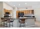 Kitchen boasts a breakfast bar with dark countertops and wooden cabinetry at 15758 W Edgemont Ave, Goodyear, AZ 85395