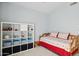 Bedroom with daybed, shelving unit, and window at 15758 W Edgemont Ave, Goodyear, AZ 85395