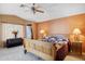 Main bedroom with wood furniture and access to backyard at 15758 W Edgemont Ave, Goodyear, AZ 85395