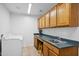 Laundry room with cabinets, sink, and washer at 15758 W Edgemont Ave, Goodyear, AZ 85395
