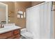 Clean bathroom with shower/tub combo, toilet, and vanity with wood cabinets at 2554 N Tambor --, Mesa, AZ 85207
