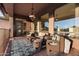 Covered patio with wicker furniture and a chandelier at 2554 N Tambor --, Mesa, AZ 85207