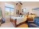 Spacious bedroom with large window, wood furniture, and carpeted floor at 2554 N Tambor --, Mesa, AZ 85207