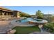 Relaxing backyard oasis featuring a large pool, spa, and fire pit at 2554 N Tambor --, Mesa, AZ 85207
