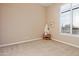 Bright bedroom with large window and neutral colored carpet at 2554 N Tambor --, Mesa, AZ 85207