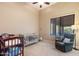 Charming Bedroom with crib, recliner, and plenty of space for baby at 2554 N Tambor --, Mesa, AZ 85207