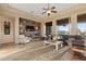Spacious living room with built-in shelving, large windows, and a cozy sitting area at 2554 N Tambor --, Mesa, AZ 85207