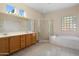 Elegant bathroom with double sinks, soaking tub, and shower at 16449 W Silver Creek Dr, Surprise, AZ 85374