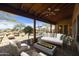 Relaxing patio with fire pit, seating area, and views of the pool and landscape at 28505 N 146Th St, Scottsdale, AZ 85262