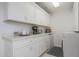 Laundry room with white cabinets, countertops, and washer/dryer at 3353 N Snead Dr, Goodyear, AZ 85395