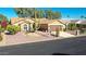 Tan house with tile roof, two-car garage, and desert landscaping at 3353 N Snead Dr, Goodyear, AZ 85395