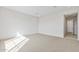 Bright bedroom with neutral walls and carpet, door to bathroom at 25952 S 224Th Pl, Queen Creek, AZ 85142