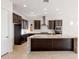 Modern kitchen with granite countertops and dark wood cabinets at 25952 S 224Th Pl, Queen Creek, AZ 85142