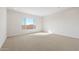 Spacious bedroom with neutral carpeting and large window at 25952 S 224Th Pl, Queen Creek, AZ 85142