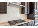 Gas cooktop with modern range hood and granite countertop at 25952 S 224Th Pl, Queen Creek, AZ 85142