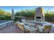Relaxing patio area with built-in fireplace and comfortable seating at 8000 E Mariposa Grande Dr, Scottsdale, AZ 85255