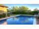Inviting swimming pool with a spacious patio and lush landscaping at 8000 E Mariposa Grande Dr, Scottsdale, AZ 85255