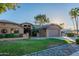 Single-story house with solar panels and mature trees at 13047 W Peach Blossom Dr, Sun City West, AZ 85375