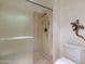 Bathroom with shower stall, toilet, and decorative gecko art at 13047 W Peach Blossom Dr, Sun City West, AZ 85375