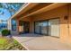 Covered patio with sliding glass doors leading to the interior at 13047 W Peach Blossom Dr, Sun City West, AZ 85375