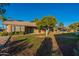Back exterior of property featuring a patio and grassy area at 13047 W Peach Blossom Dr, Sun City West, AZ 85375