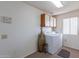 Laundry room with washer, dryer, and overhead cabinets at 13047 W Peach Blossom Dr, Sun City West, AZ 85375
