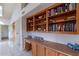 Built-in wooden shelving with books and decorative items at 13047 W Peach Blossom Dr, Sun City West, AZ 85375