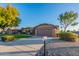 Single-story house with brown garage door and desert landscaping at 13047 W Peach Blossom Dr, Sun City West, AZ 85375