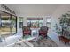 Sunroom with wicker chairs, a small table, and large windows overlooking the outdoors at 13047 W Peach Blossom Dr, Sun City West, AZ 85375