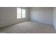 Spacious bedroom with large window and carpeted floor at 1749 E Wildflower Ln, Casa Grande, AZ 85122