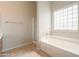 Bathroom features a soaking tub, shower, and large window at 1749 E Wildflower Ln, Casa Grande, AZ 85122