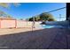 Refreshing kidney-shaped pool with a storage shed at 2022 W Aster Dr, Phoenix, AZ 85029