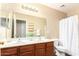 Bathroom with double vanity, shower, and updated fixtures at 18774 N Ibis Way, Maricopa, AZ 85138