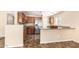 Kitchen with wood cabinets, stainless steel appliances and breakfast bar at 18774 N Ibis Way, Maricopa, AZ 85138