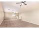 Spacious bedroom with high ceilings, ceiling fan and carpet flooring at 18774 N Ibis Way, Maricopa, AZ 85138