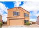 Two-story house with tan exterior and double garage at 18774 N Ibis Way, Maricopa, AZ 85138
