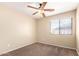Charming bedroom with ceiling fan and a window at 18774 N Ibis Way, Maricopa, AZ 85138