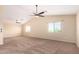 Spacious bedroom with ceiling fan and large windows at 18774 N Ibis Way, Maricopa, AZ 85138